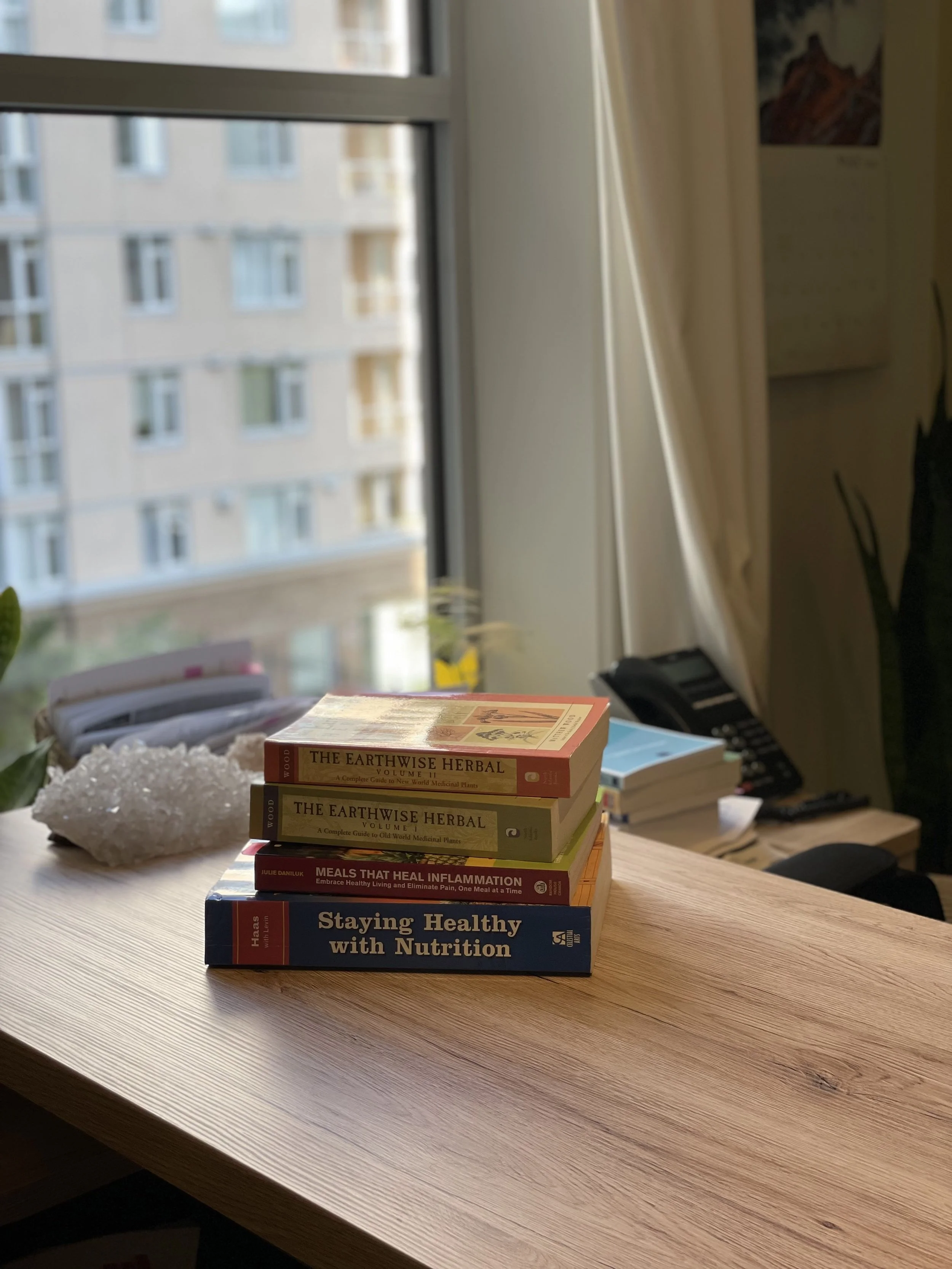 Stack of books in an office at Circle Integrative Wellness