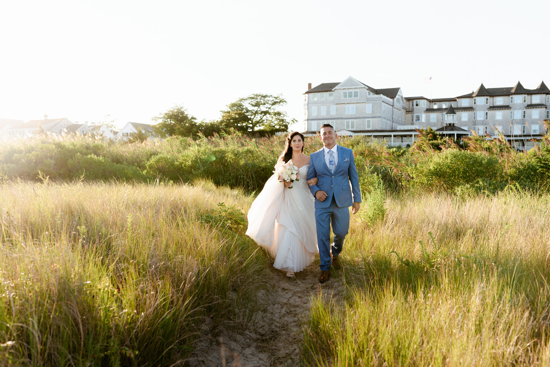 couple walking down the aisle of Dunes.jpg