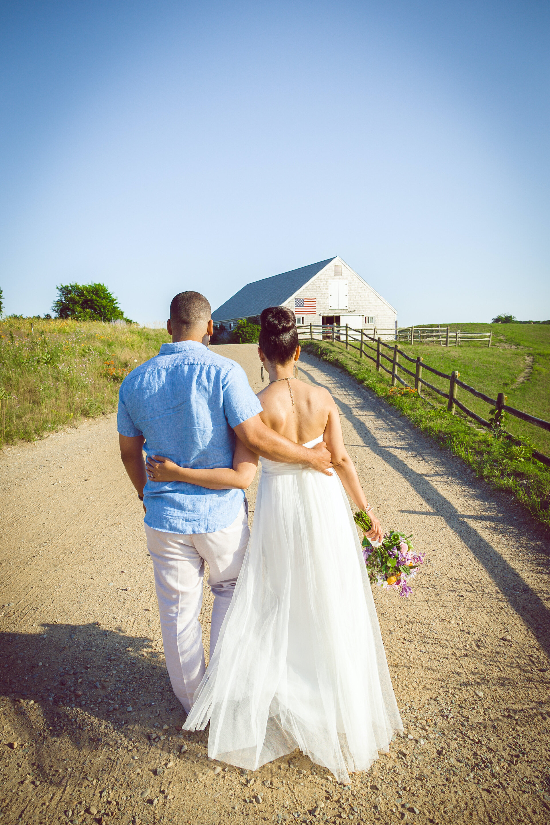 Couple walking to barn after wedding.jpg