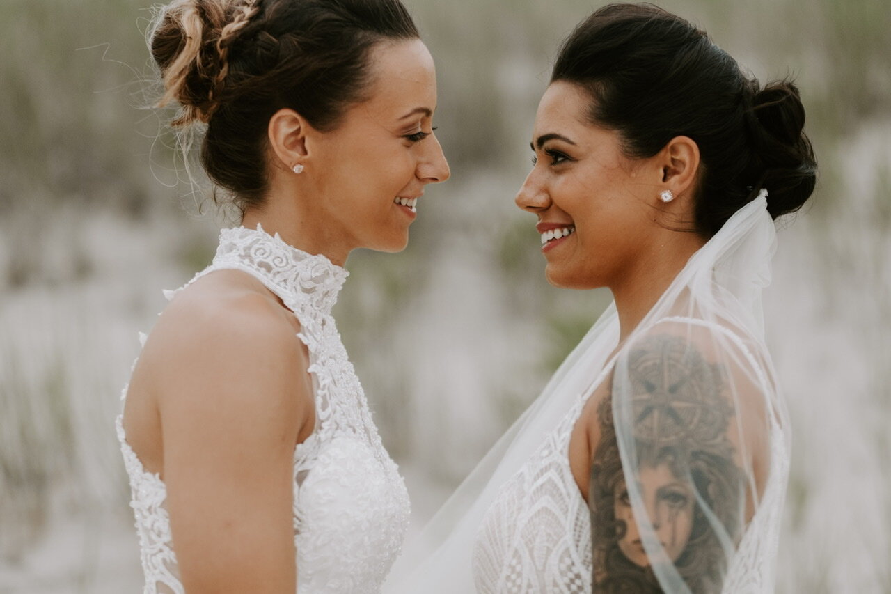 Two brides gazing into each other’s eyes