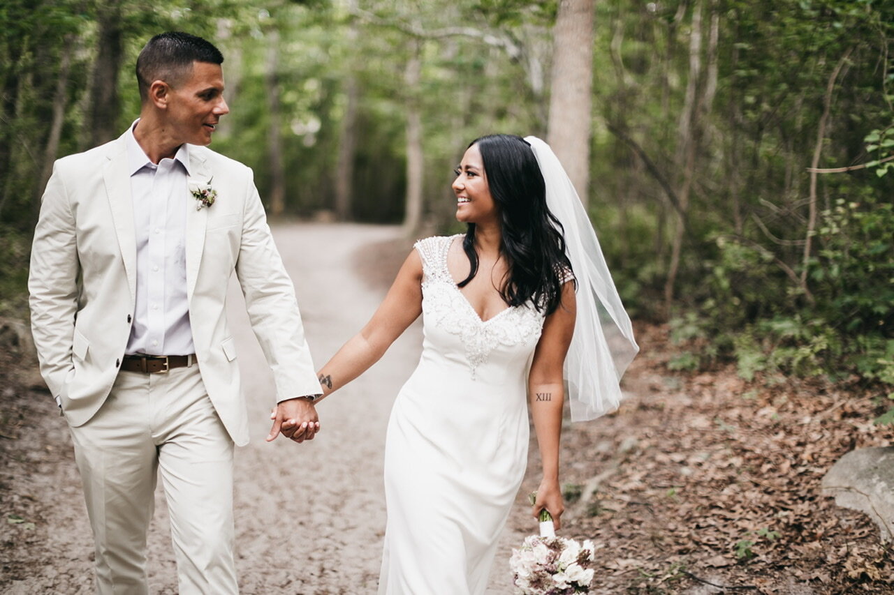 A couple walking through a wooded path