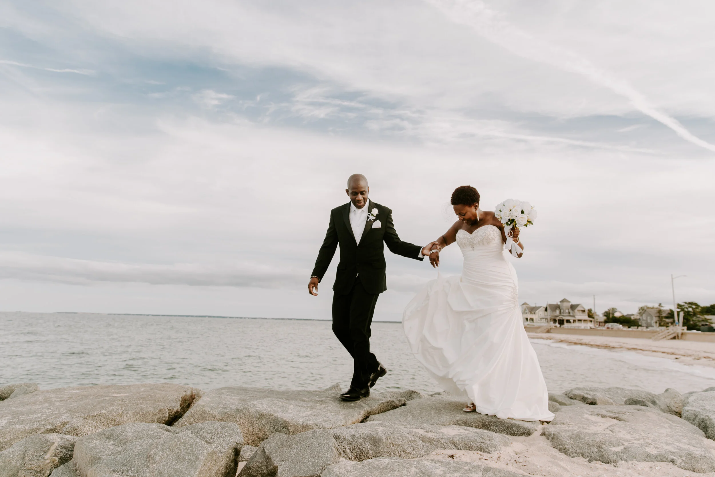 Couple walking along the rocks together.