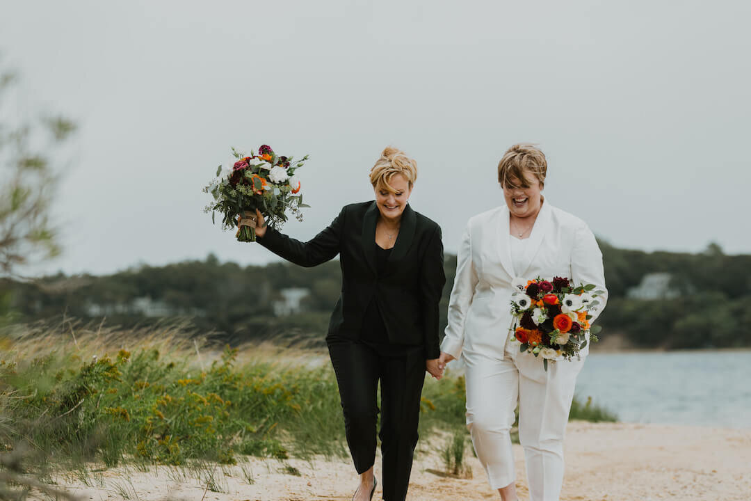Couple eloping holding beautiful bouquets on beach.jpg