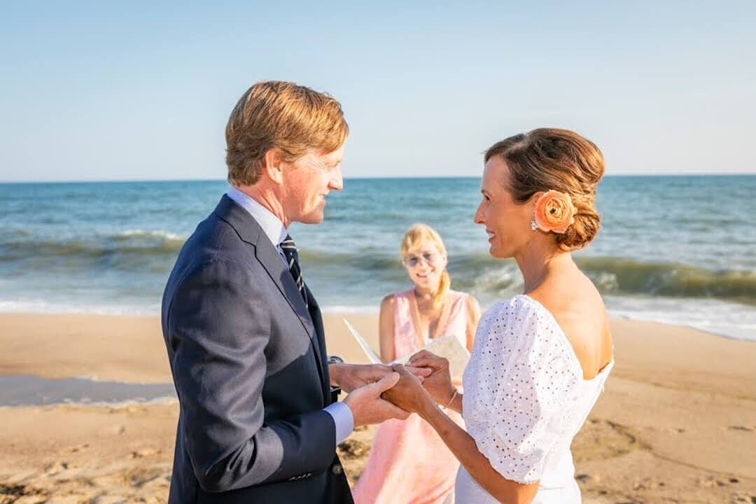 couple holding hands during beachfront elopement ceremony on MV.jpg
