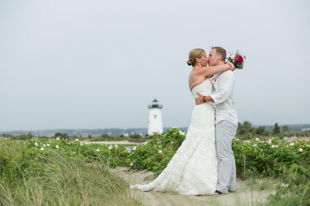 couple kissing in the dunes with Edgartown lighthouse in background.jpg