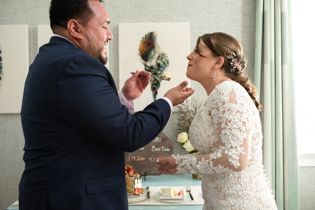 couple take first bites of wedding cake on Marthas Vineyard.jpg