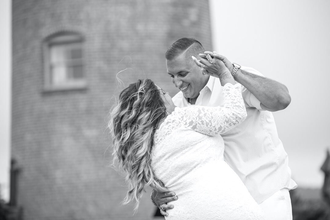 Newlyweds dancing on Marthas Vineyard beach by Lighthouse.jpg