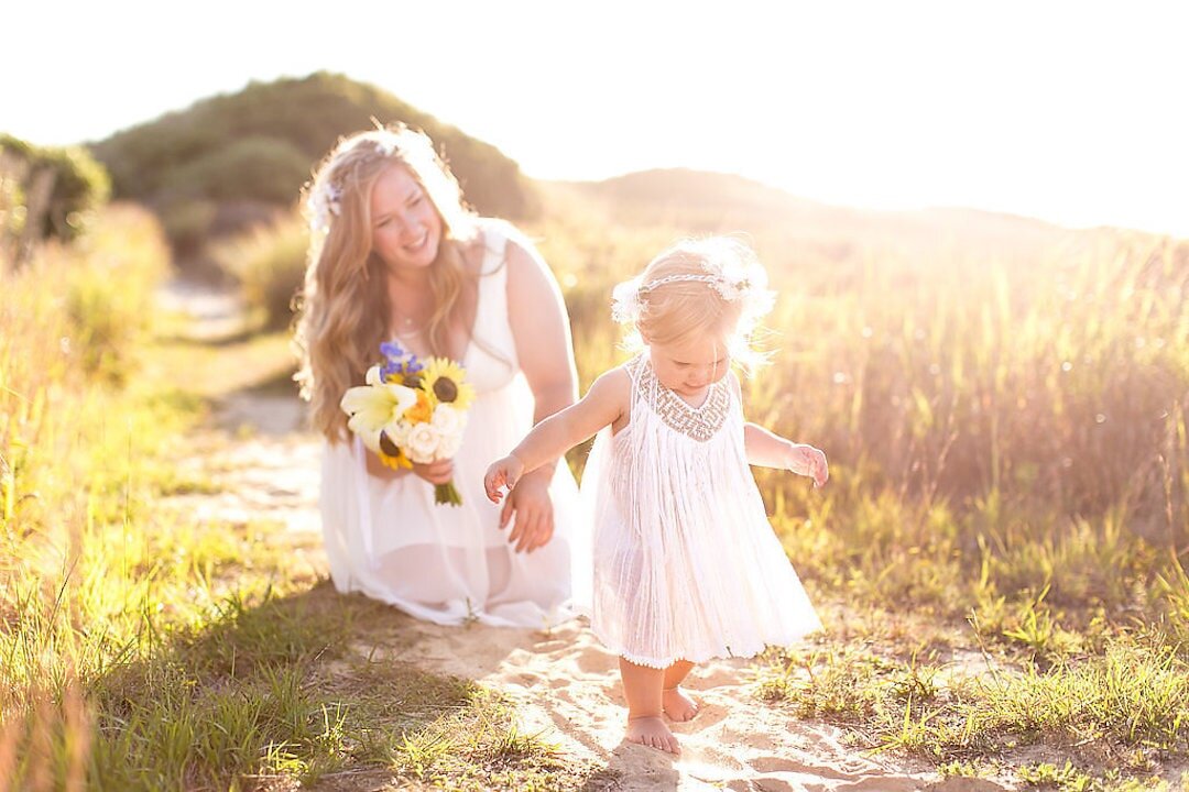 Woman walking behind flower girl in a field on Marthas Vineyard.jpg