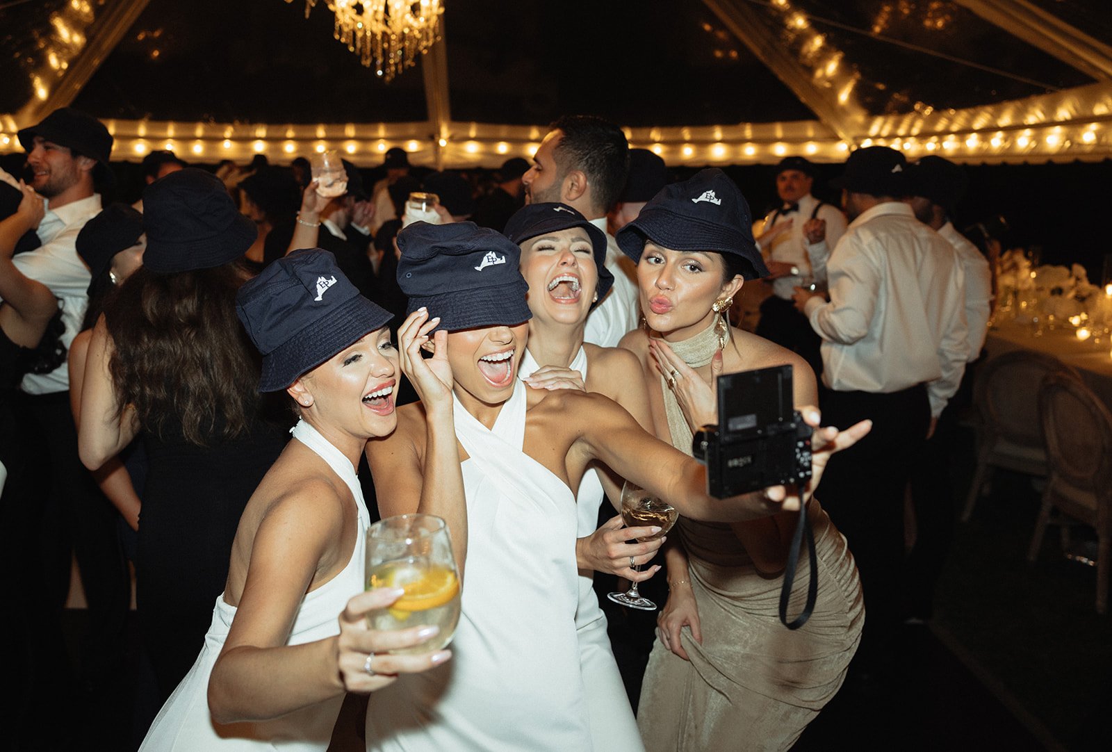 Bridesmaids take a selfie on dance floor with Martha's Vineyard bucket hats