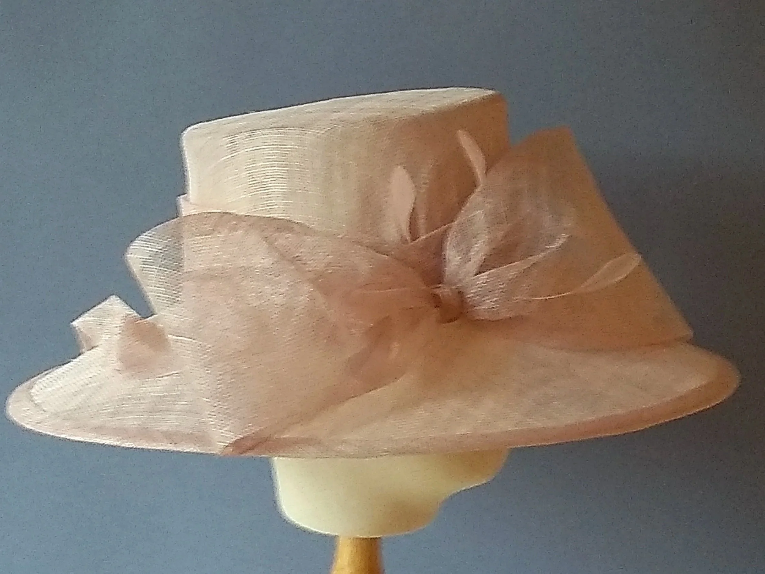 Delicate pale pink sinamay wedding hat with an extra-large sinamay bow.