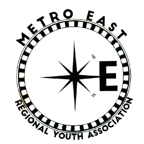 A black circular logo with the words 'METRO EAST REGIONAL YOUTH ASSOCIATION' around the edge and a compass rose in the center. The letters 'E' and 'N' are marked on the right and top, respectively.