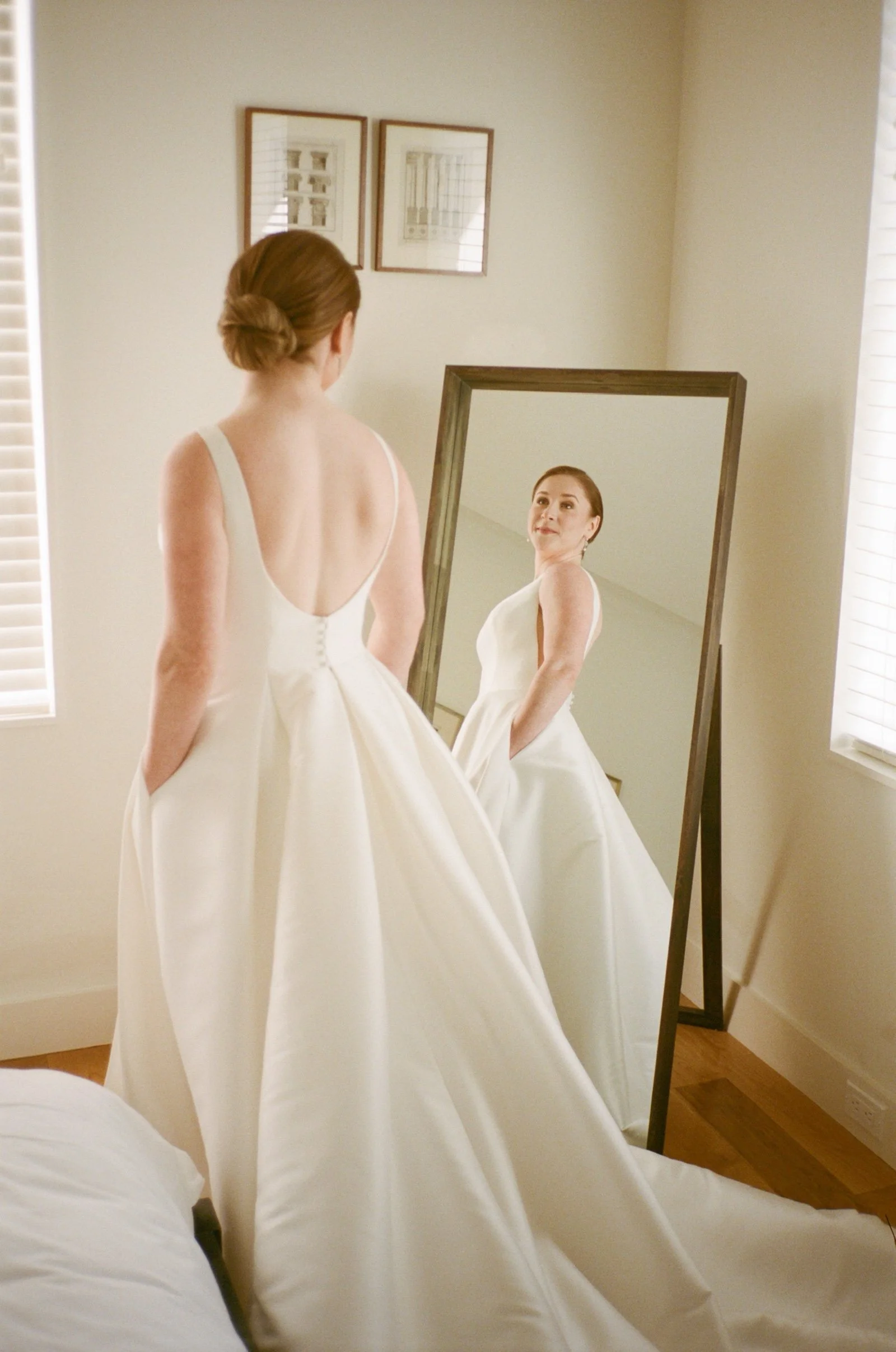 Bride looks at her reflection in mirror
