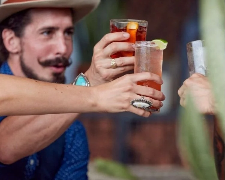 People raising glasses with cocktails at a social gathering
