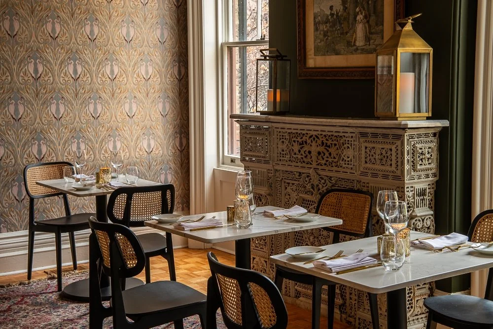 drink toast in front of an elegant chandelier