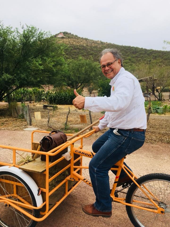 Joaquin Murrieta Saldivar on bike in garden.jpg