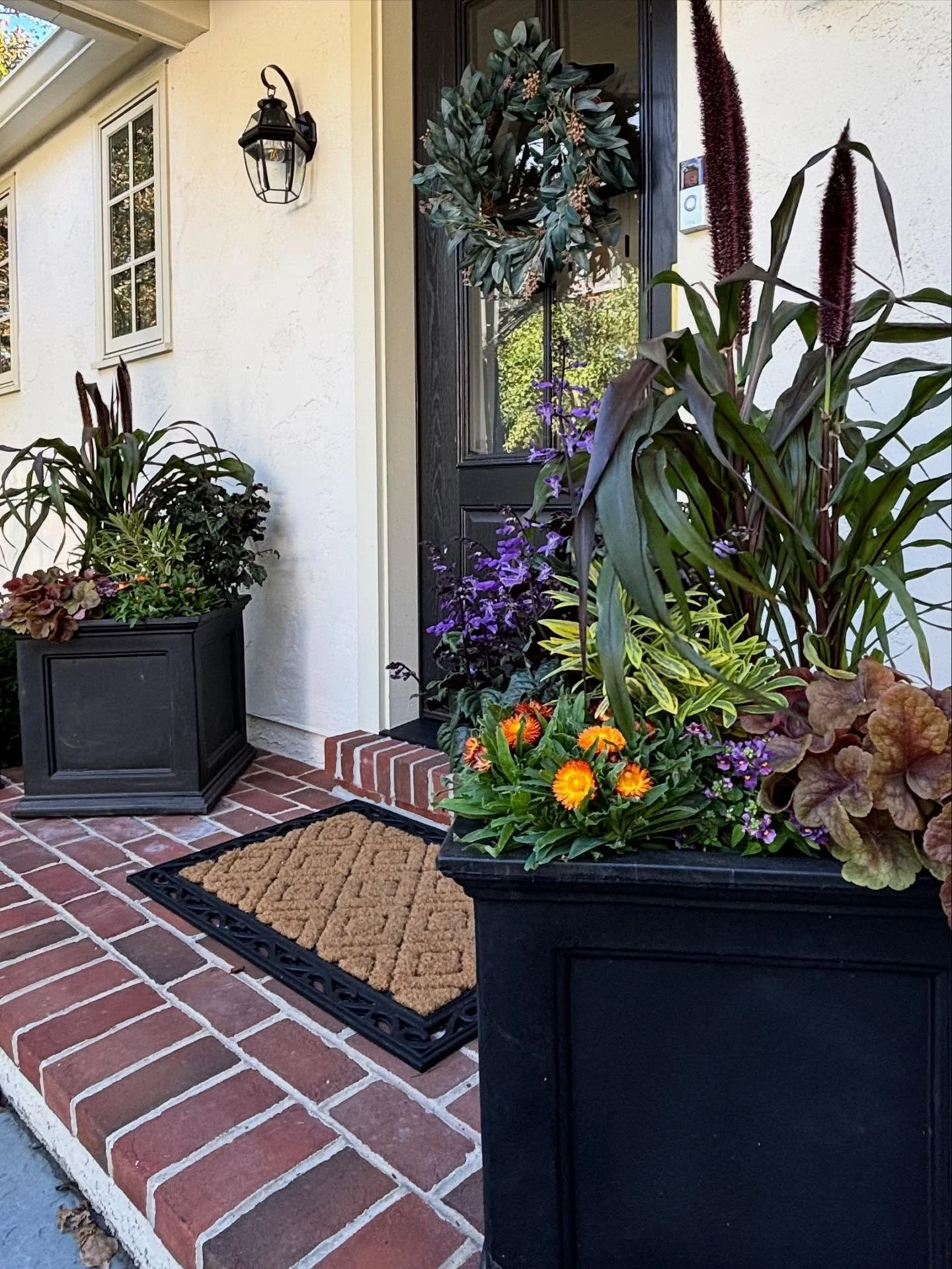 Welcome Home 🌿
 We warmed up this doorstep with a fresh pair of containers&mdash;and wow, what a difference! I&rsquo;m always amazed at how something so simple can have such a big impact.

A thoughtfully styled set of planters flanking the doorway a