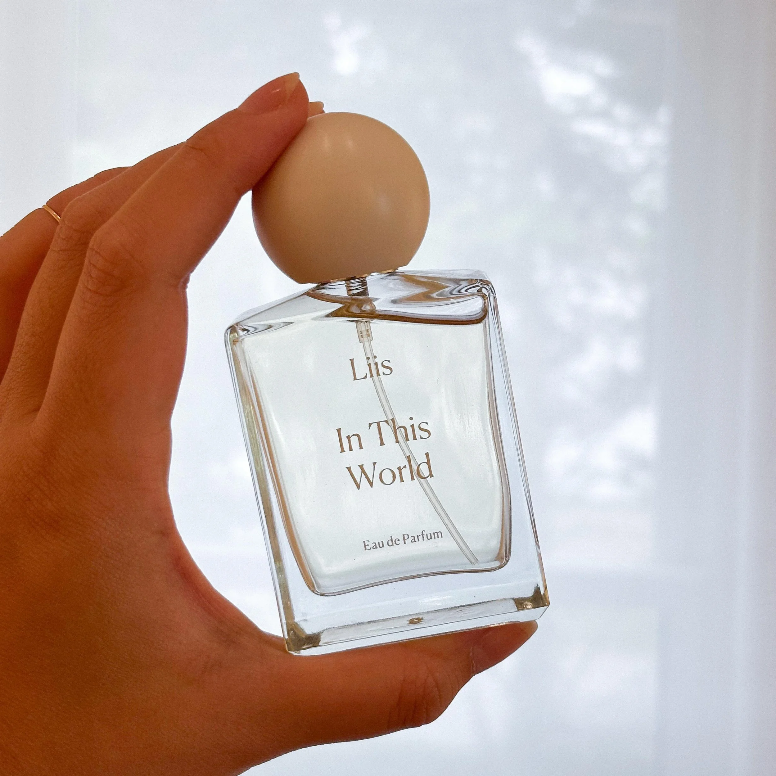 In This World by @liisfragrances . Natural eau de parfum with subtle notes of blood orange, eucalyptus, fig, violet, lavender, tonka wood and sage. Made in California. 🌸