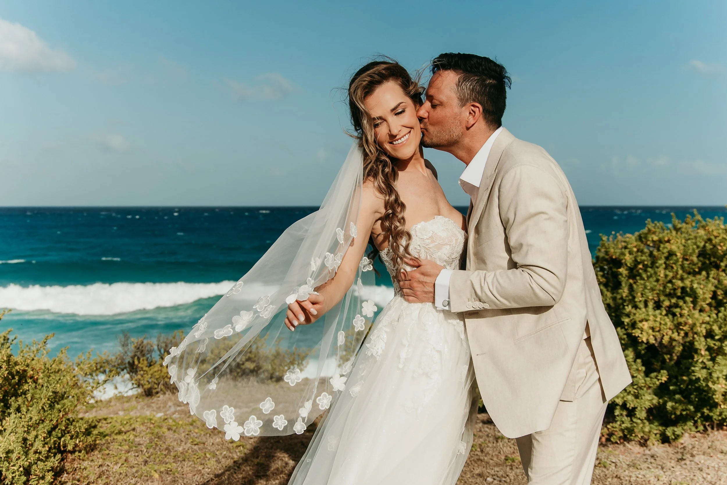 isla-mujeres-wedding-photographer-groom-kissing-brides-cheek.jpg