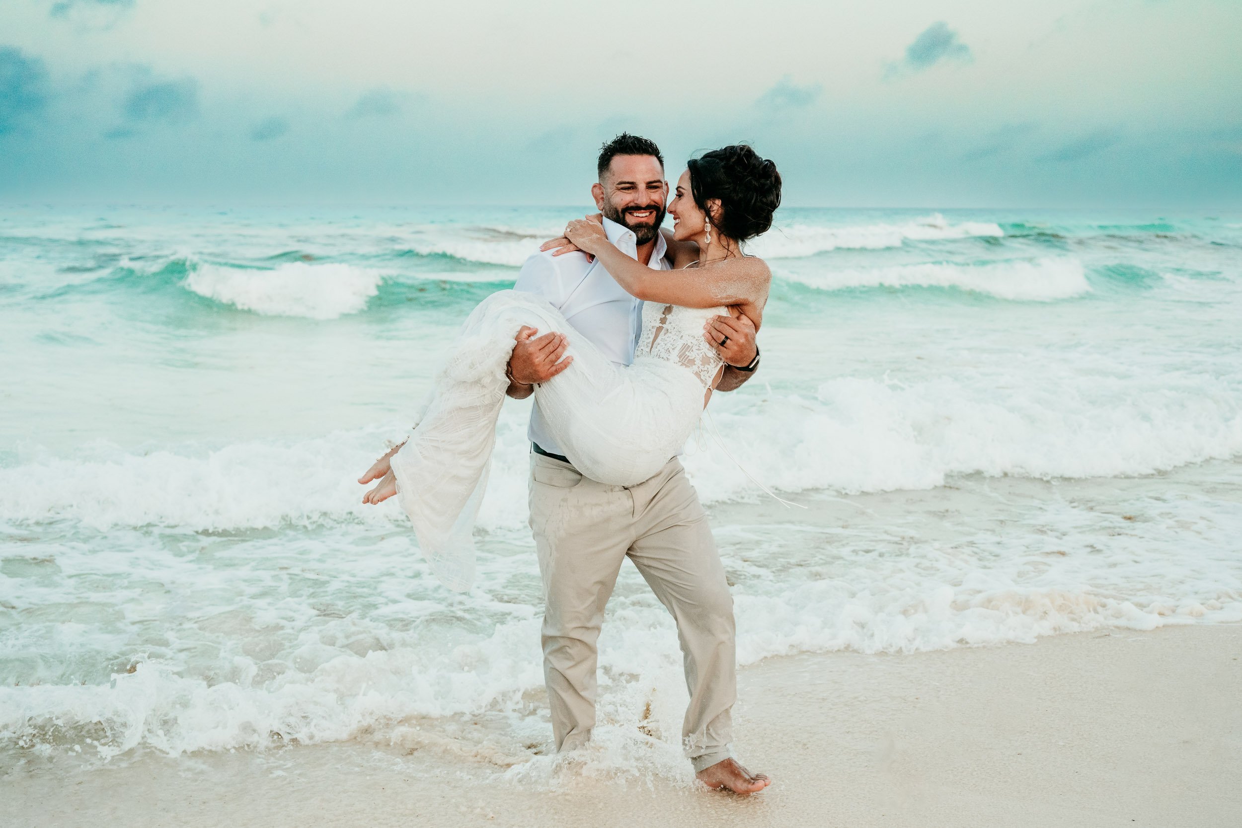 live-aqua-cancun-wedding-photography-groom-carrying-bride.jpg