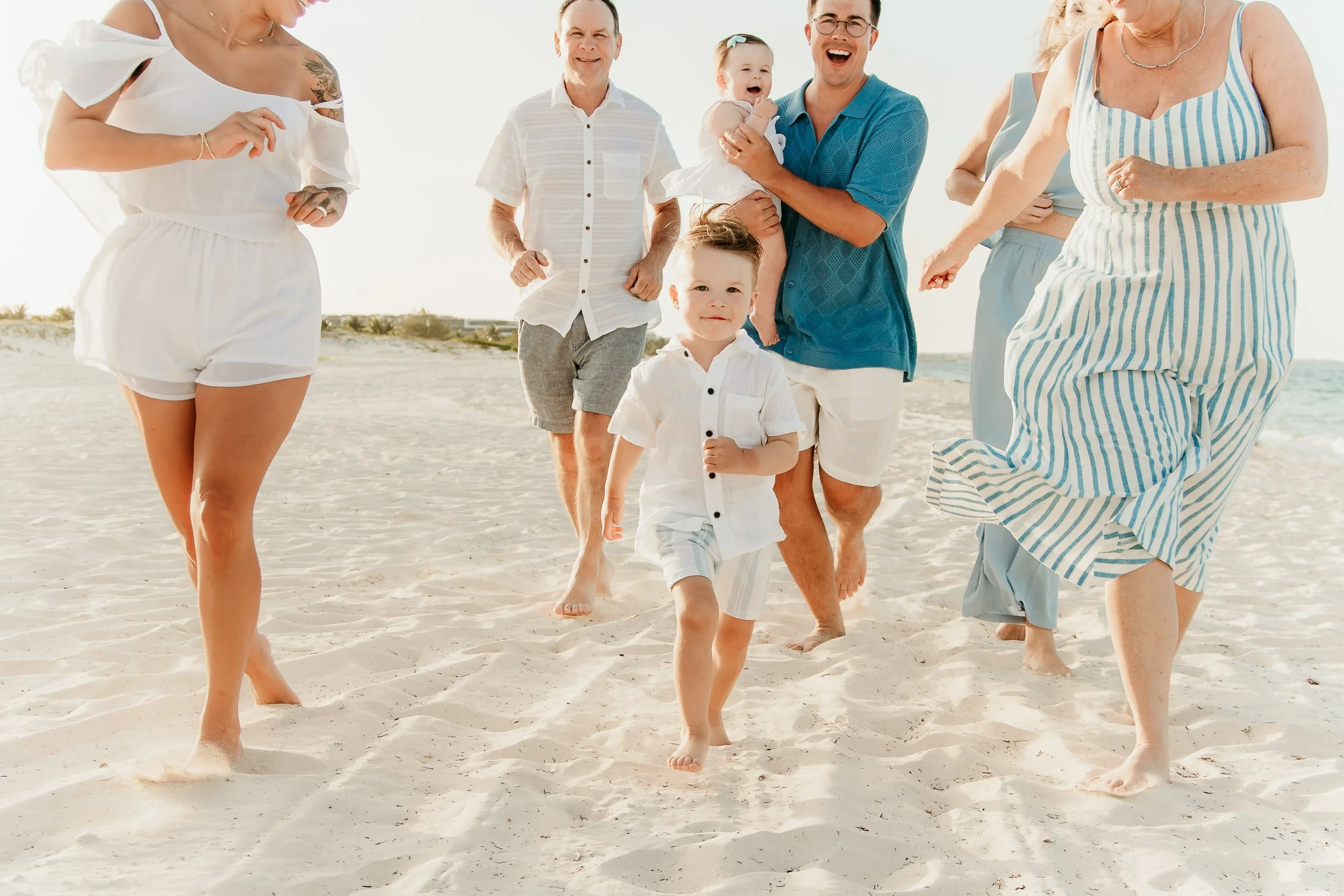 dreams-playa-mujeres-cancun-photography-family-running-on-beach.jpg
