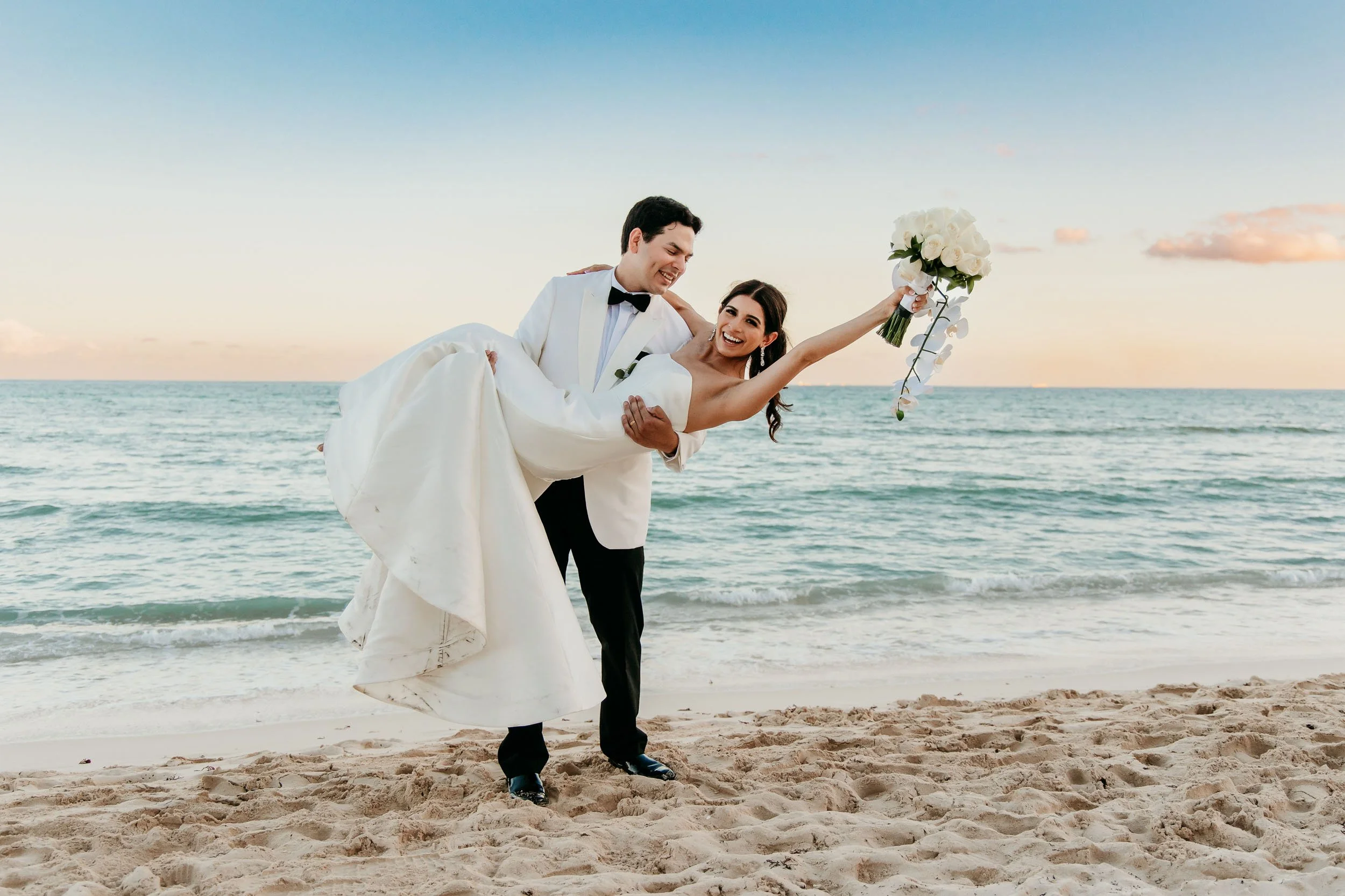 grand-riviera-princess-playa-del-carmen-wedding-photographer-groom-carrying-bride.jpg