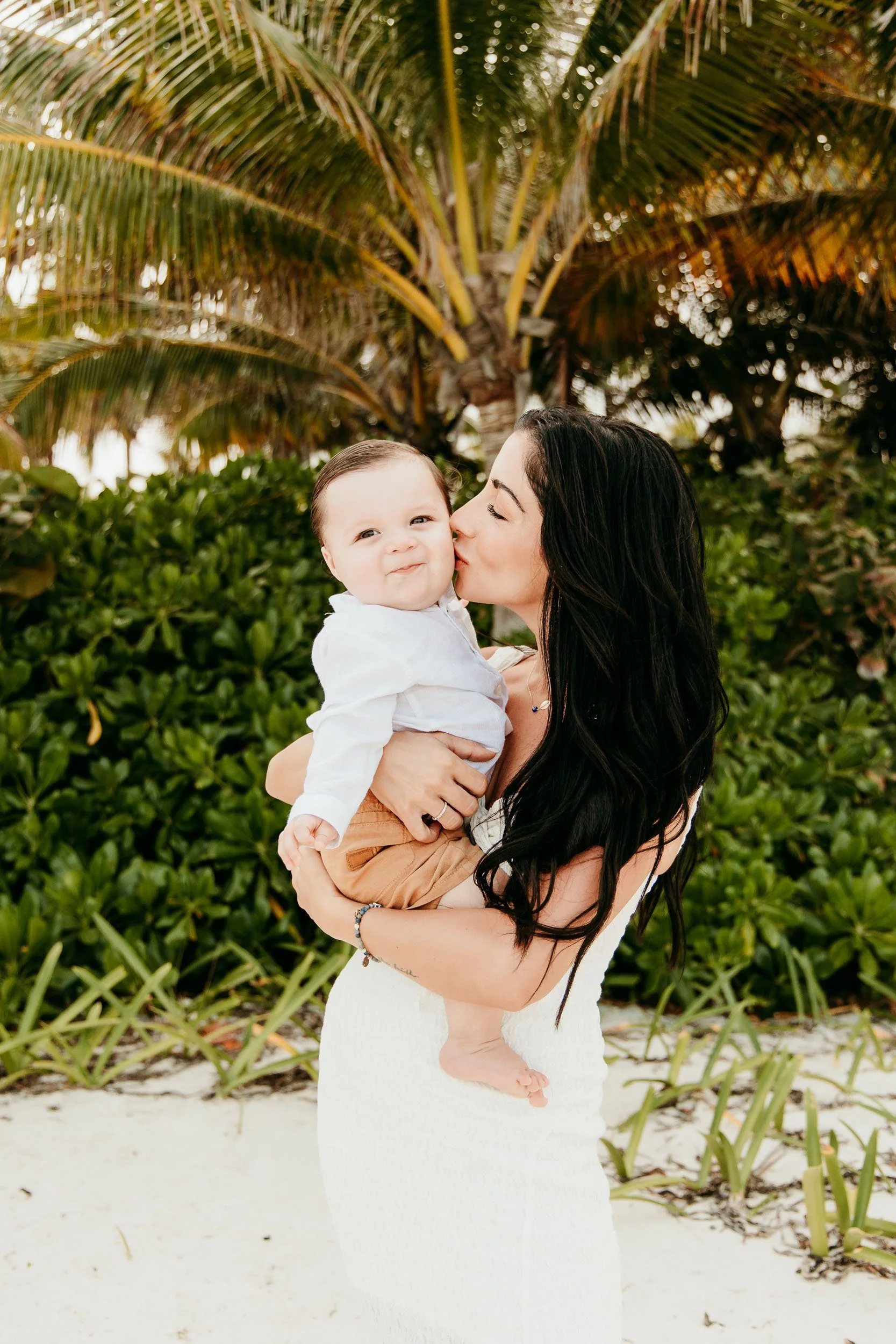 rosewood-mayakoba-riviera-maya-photographer-mom-kissing-baby.jpg