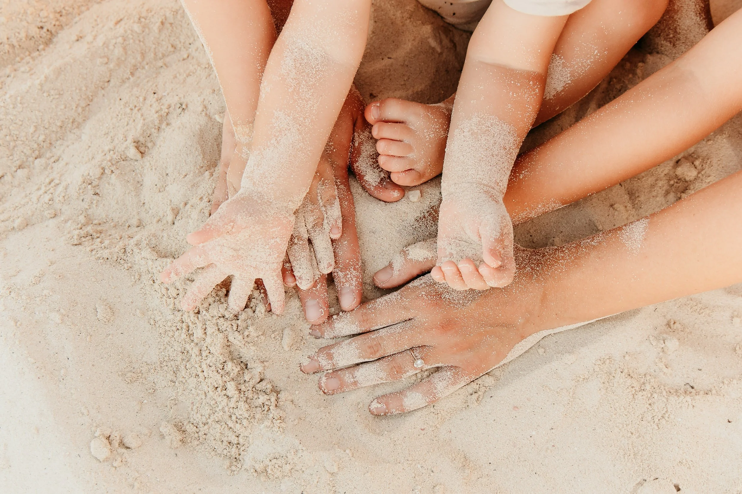 cancun-family-photography-hands-in-the-sand.jpg