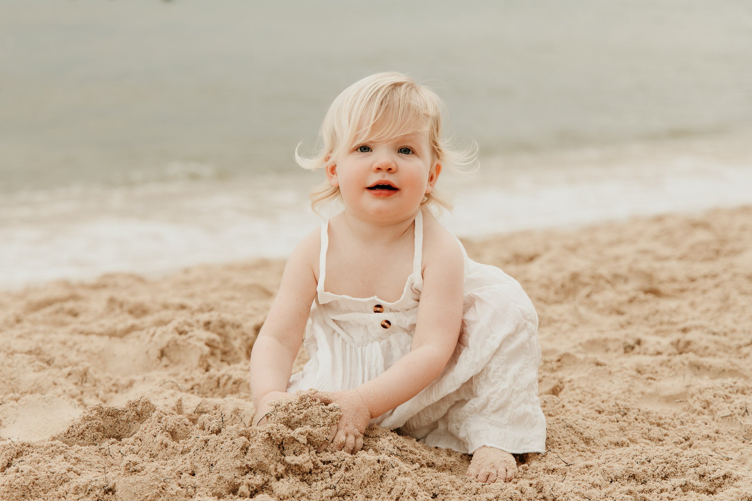 cancun-family-photographer-baby-playing-in-sand.jpg