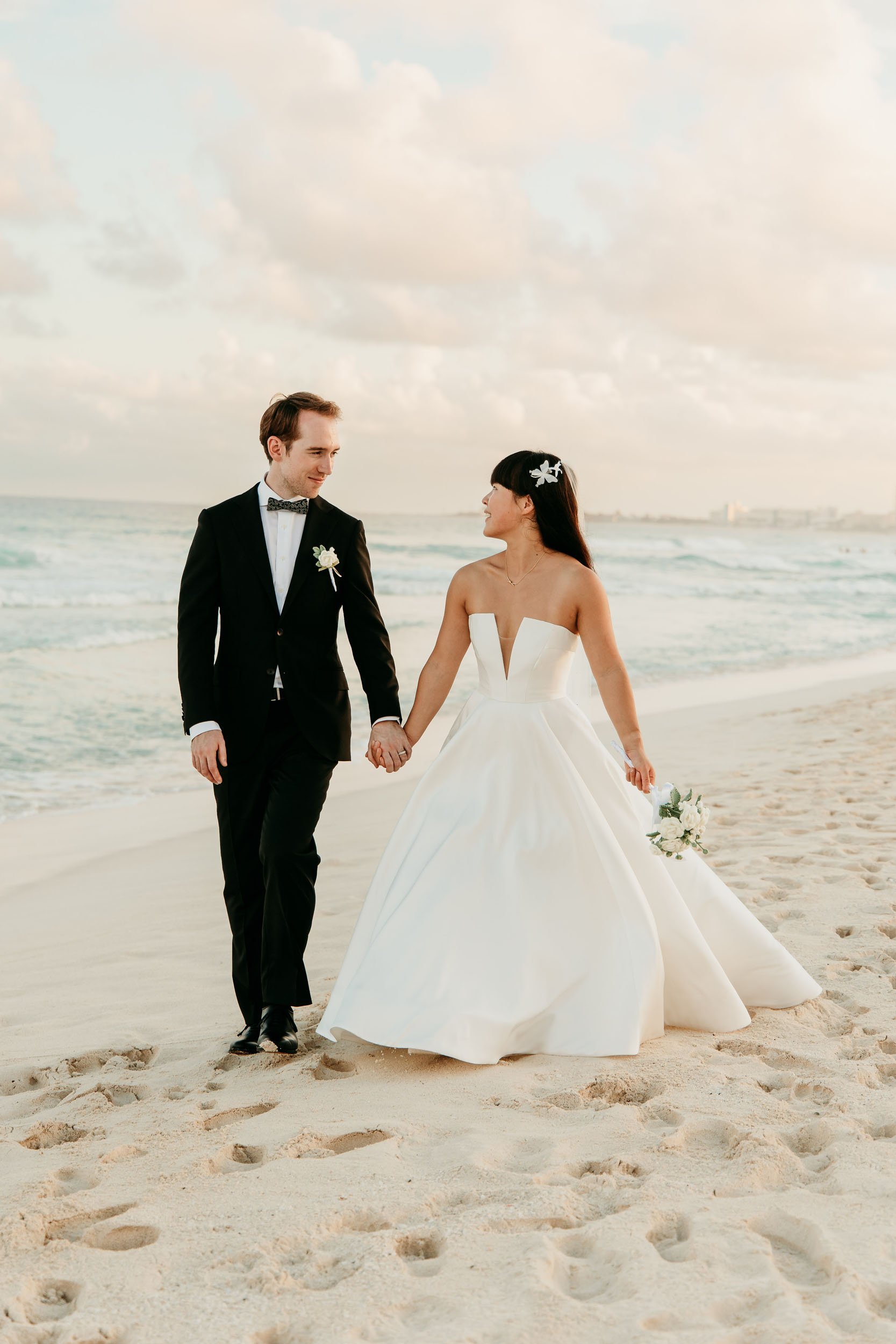 iberostar-cancun-wedding-photographer-couple-holding-hands-ocean.jpg