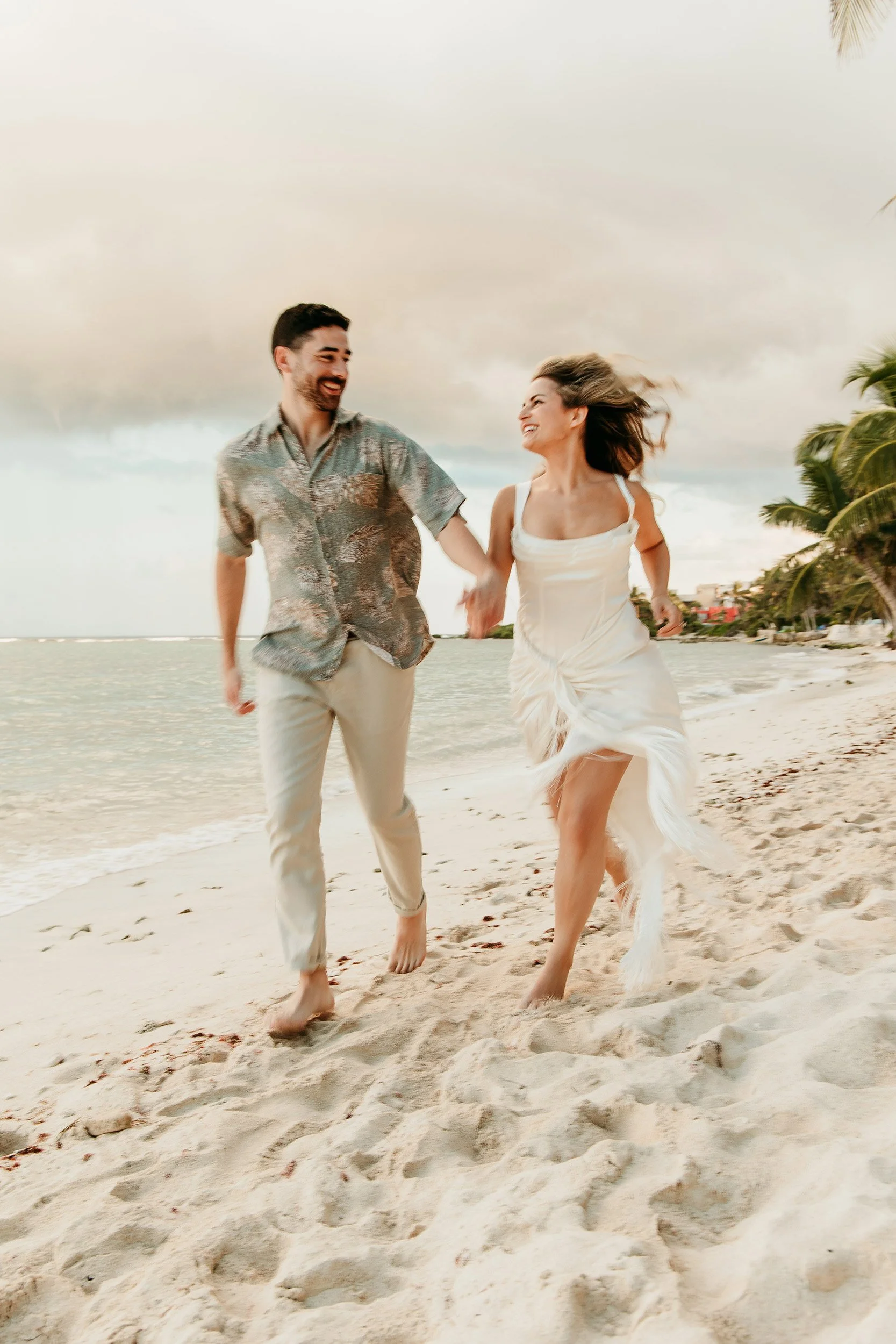 hard-rock-riviera-maya-engagement-photographer-couple-running-beach.jpg