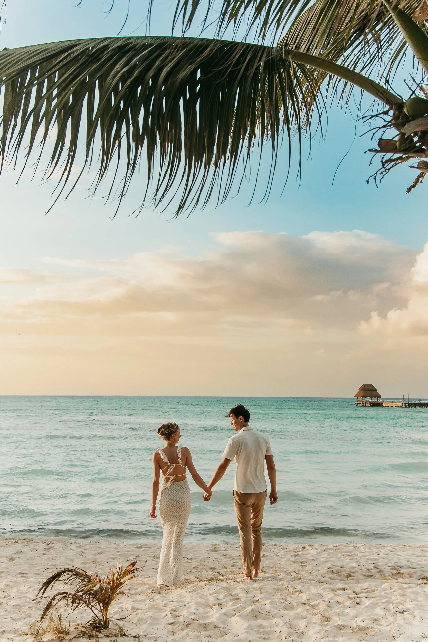isla-mujeres-engagement-photographer-couple-holding-hands-on-beach.jpg