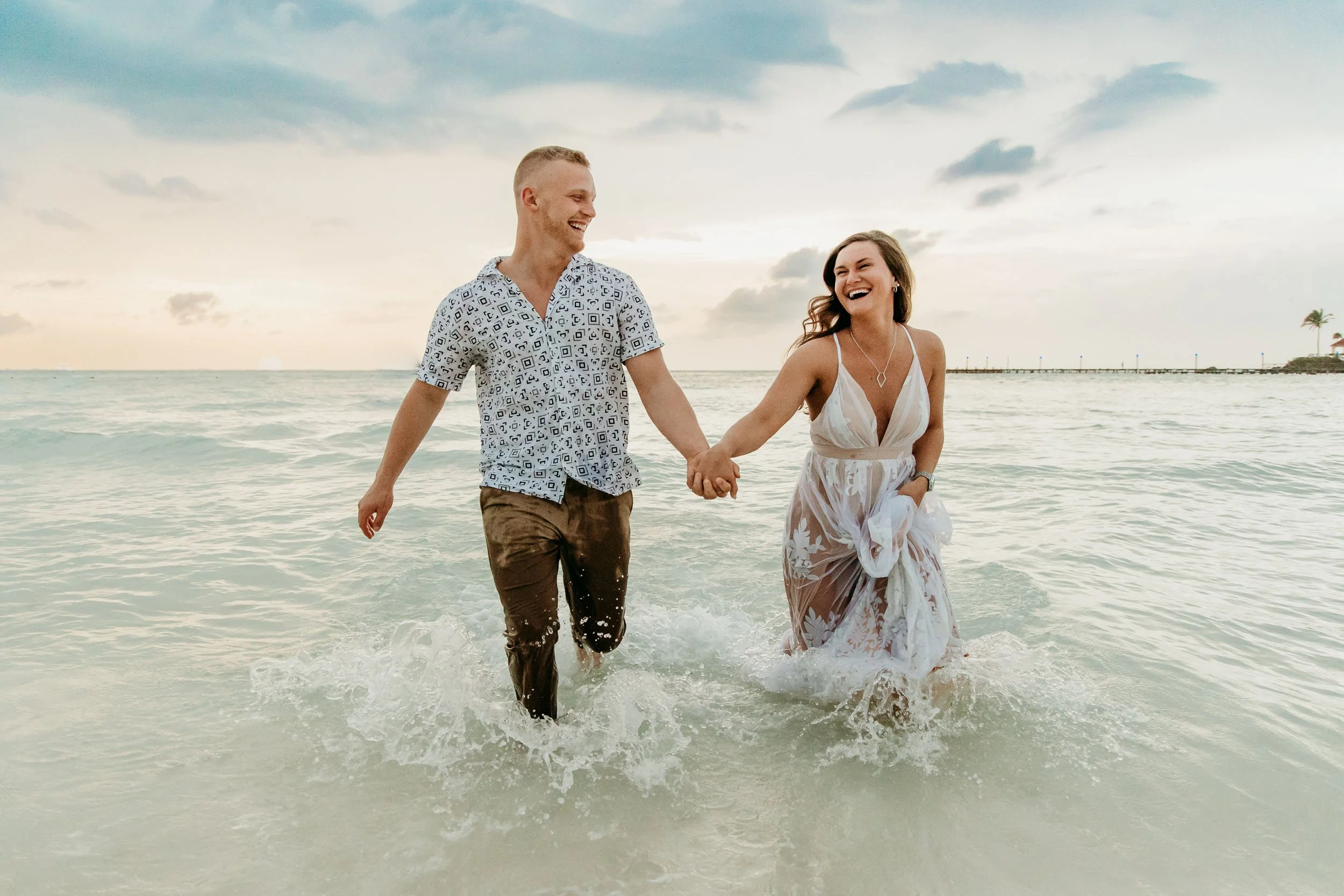 isla-mujeres-photographer-couple-running-in-ocean.jpg