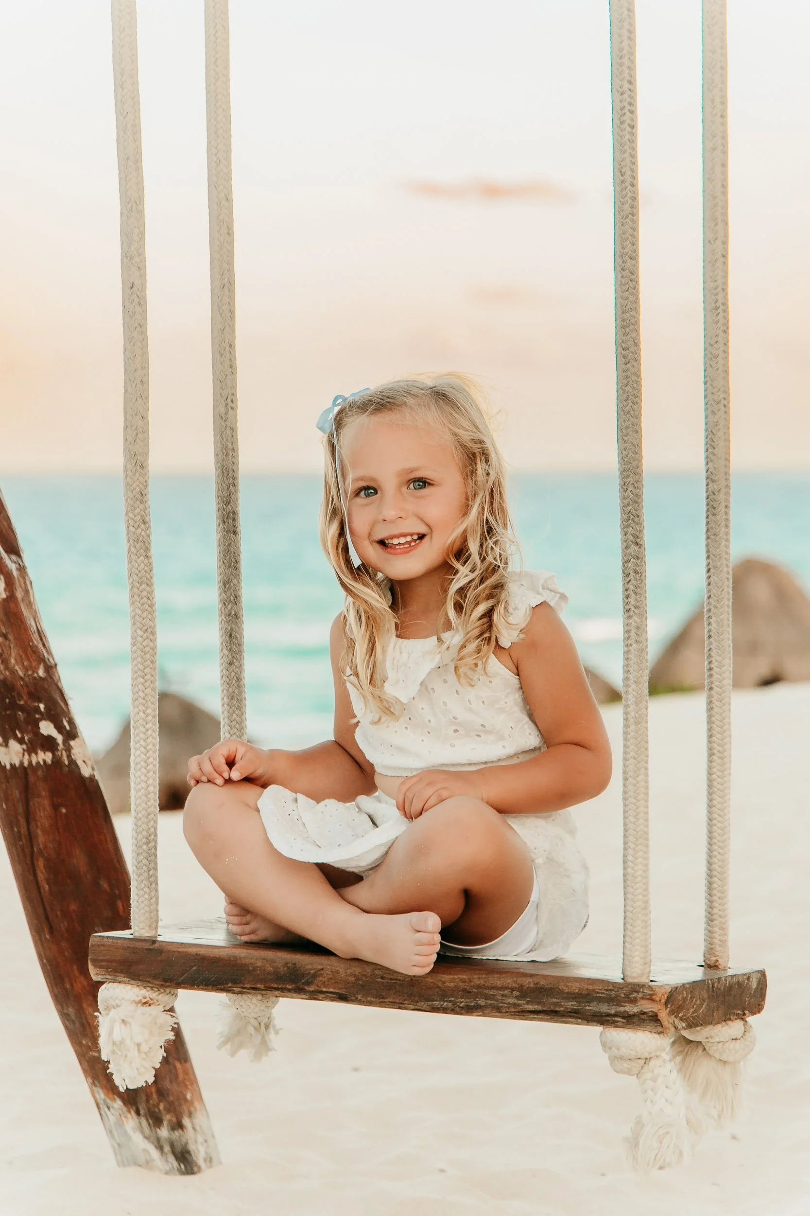 cancun-family-photographer-sitting-on-swingset.jpg