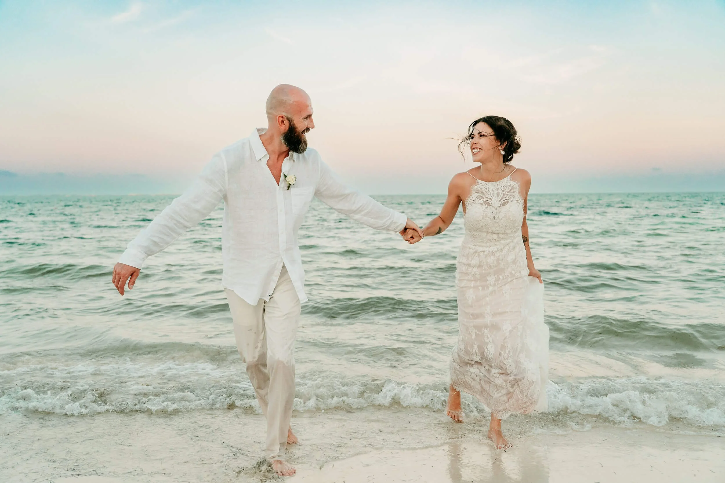 villa-del-palmar-cancun-wedding-photographer-couple-running-on-beach.jpg