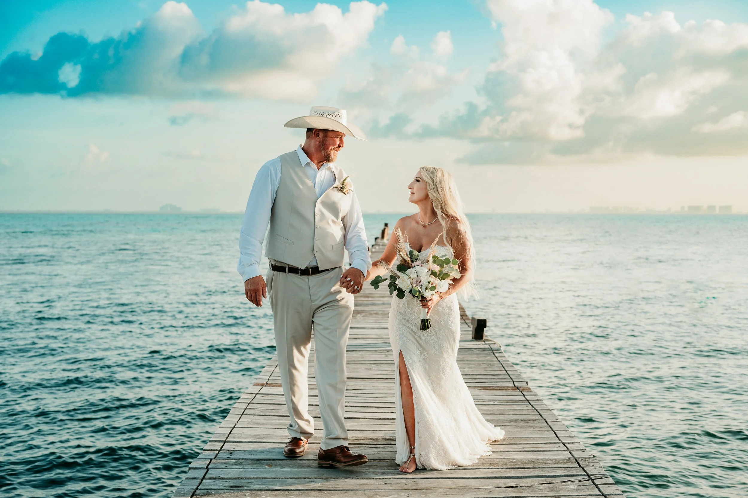 destination-wedding-photography-cancun-bride-groom-walking-on-pier.jpg