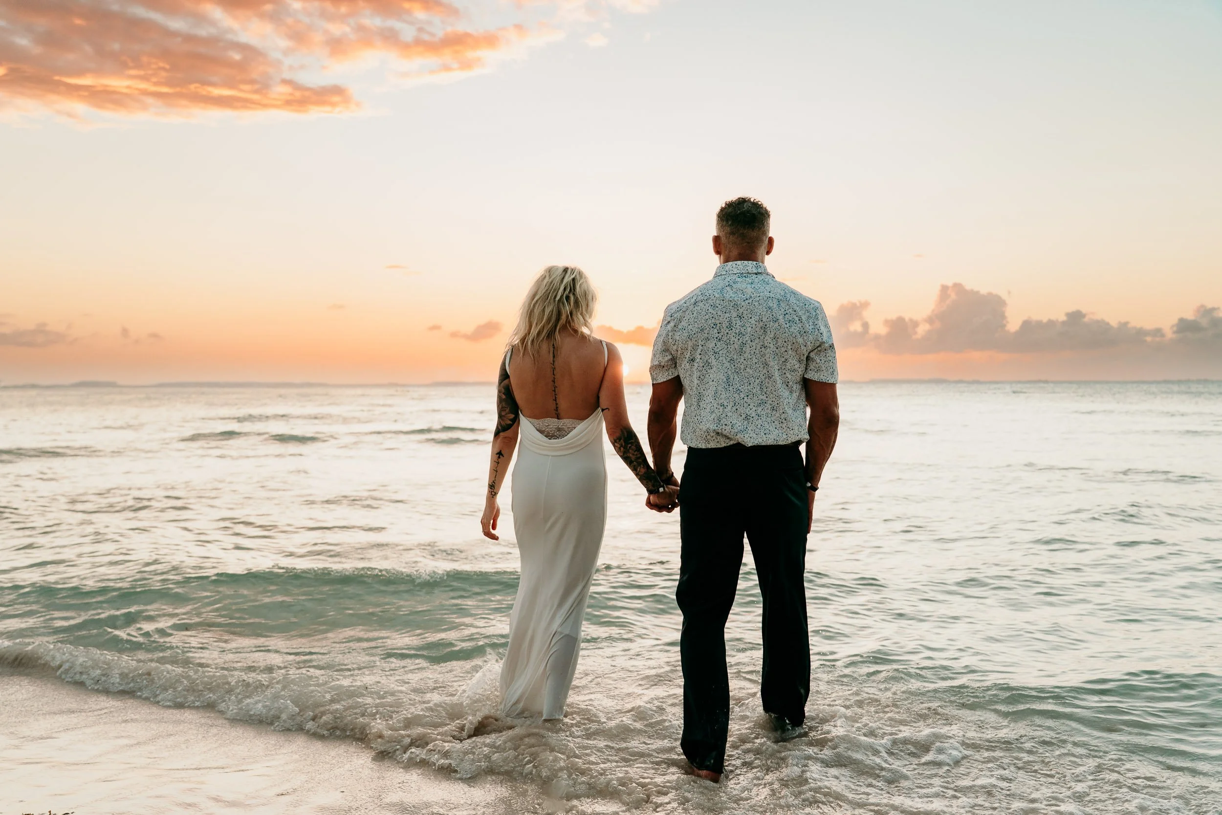 isla-mujeres-wedding-photographer-couple-walking-into-ocean.jpg