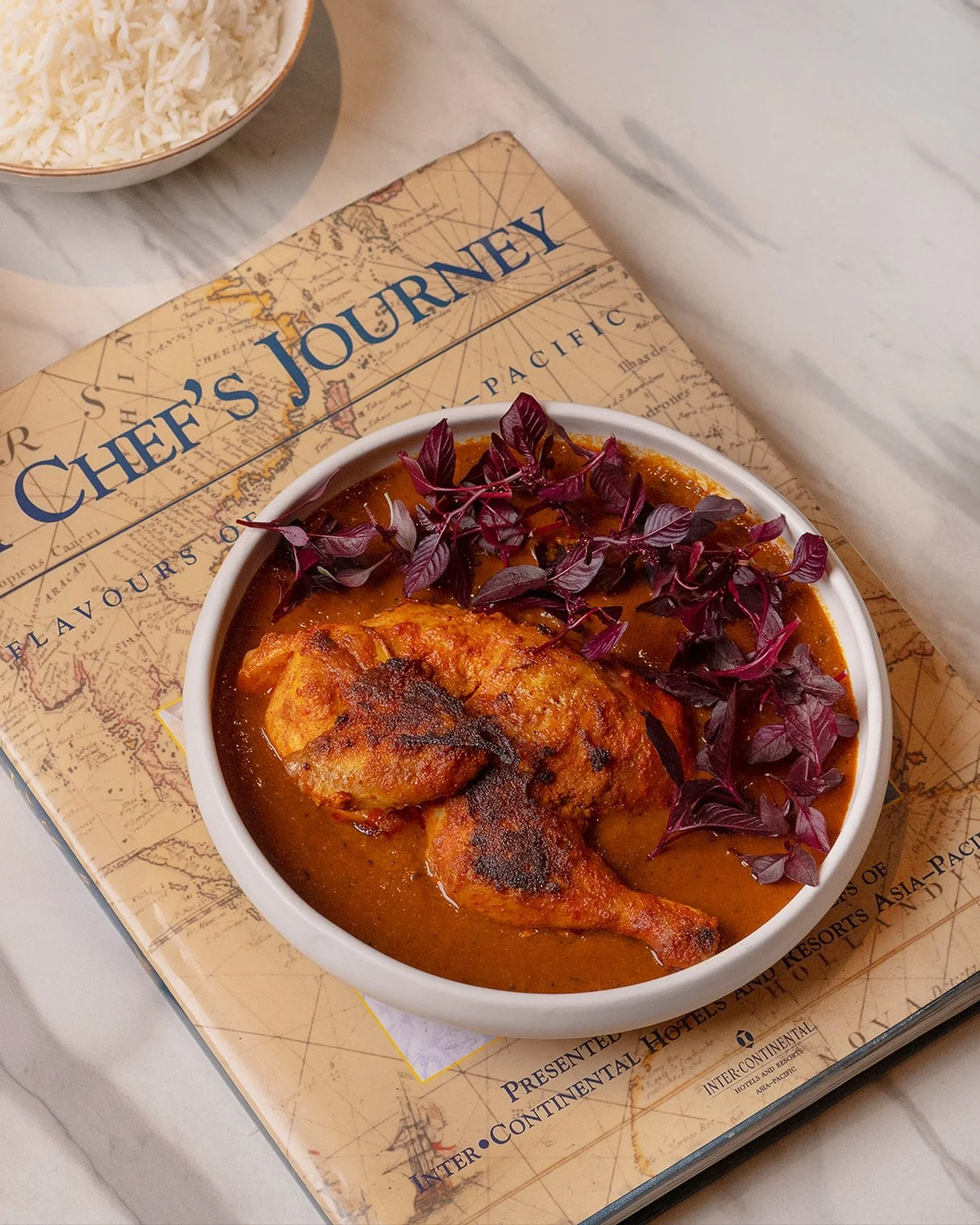Every dish tells a story&mdash;and this one maps flavour across continents. 

Our charred soya chicken, rich in spice and rooted in Indian culinary tradition, sits atop a journey of taste.
 
It&rsquo;s comfort food with a passport.
 
For reservations
