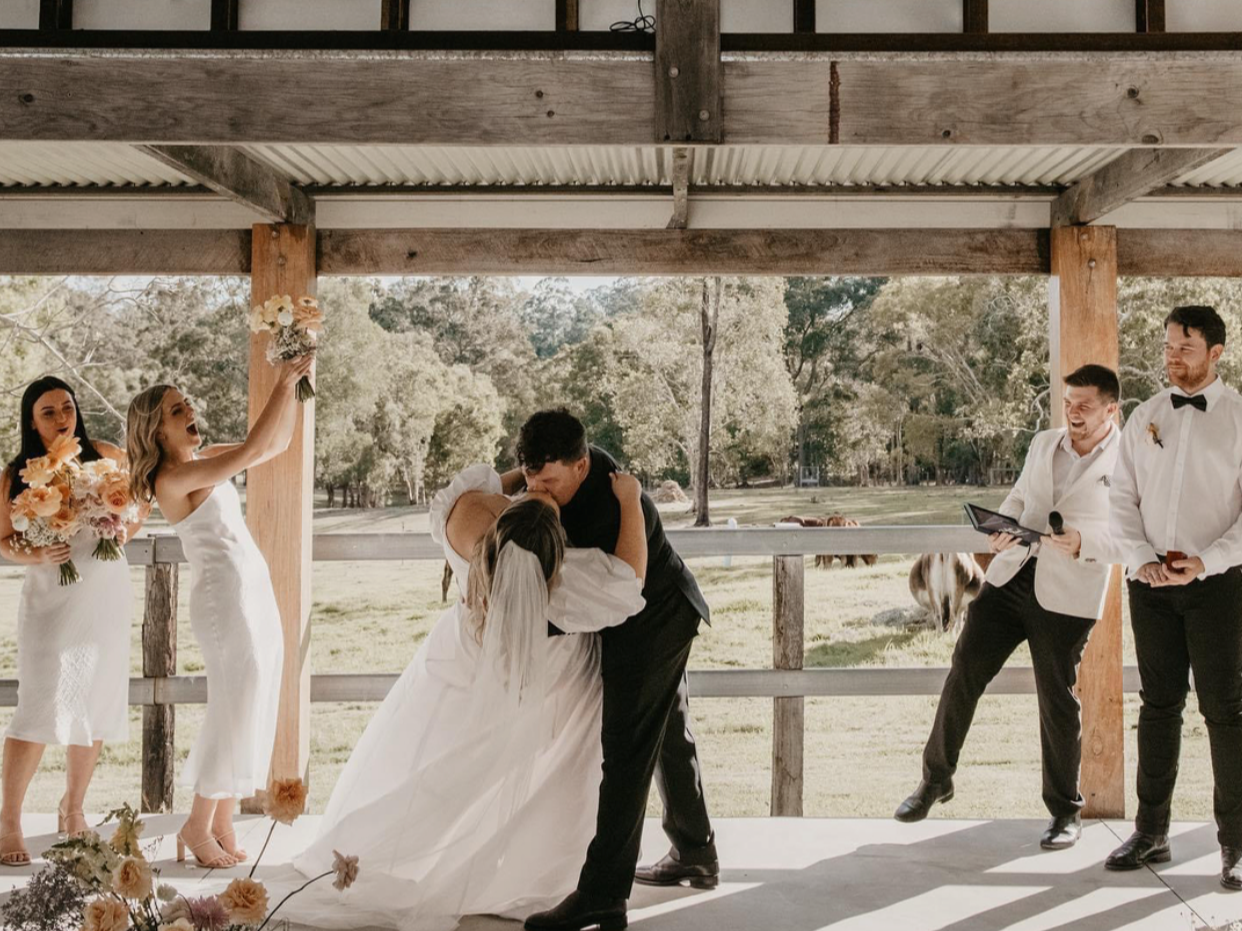 Bride and groom kissing after wedding ceremony on Gold Coast farm wedding venue