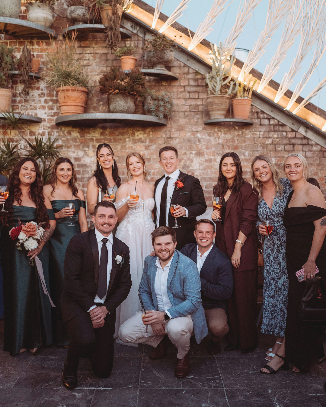 Bride, groom and bridal party celebrating at a Brisbane wedding reception