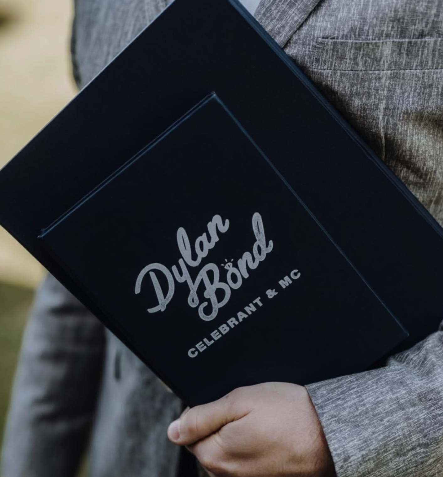 Gold Coast Celebrant & MC holding folder a Burleigh Heads wedding