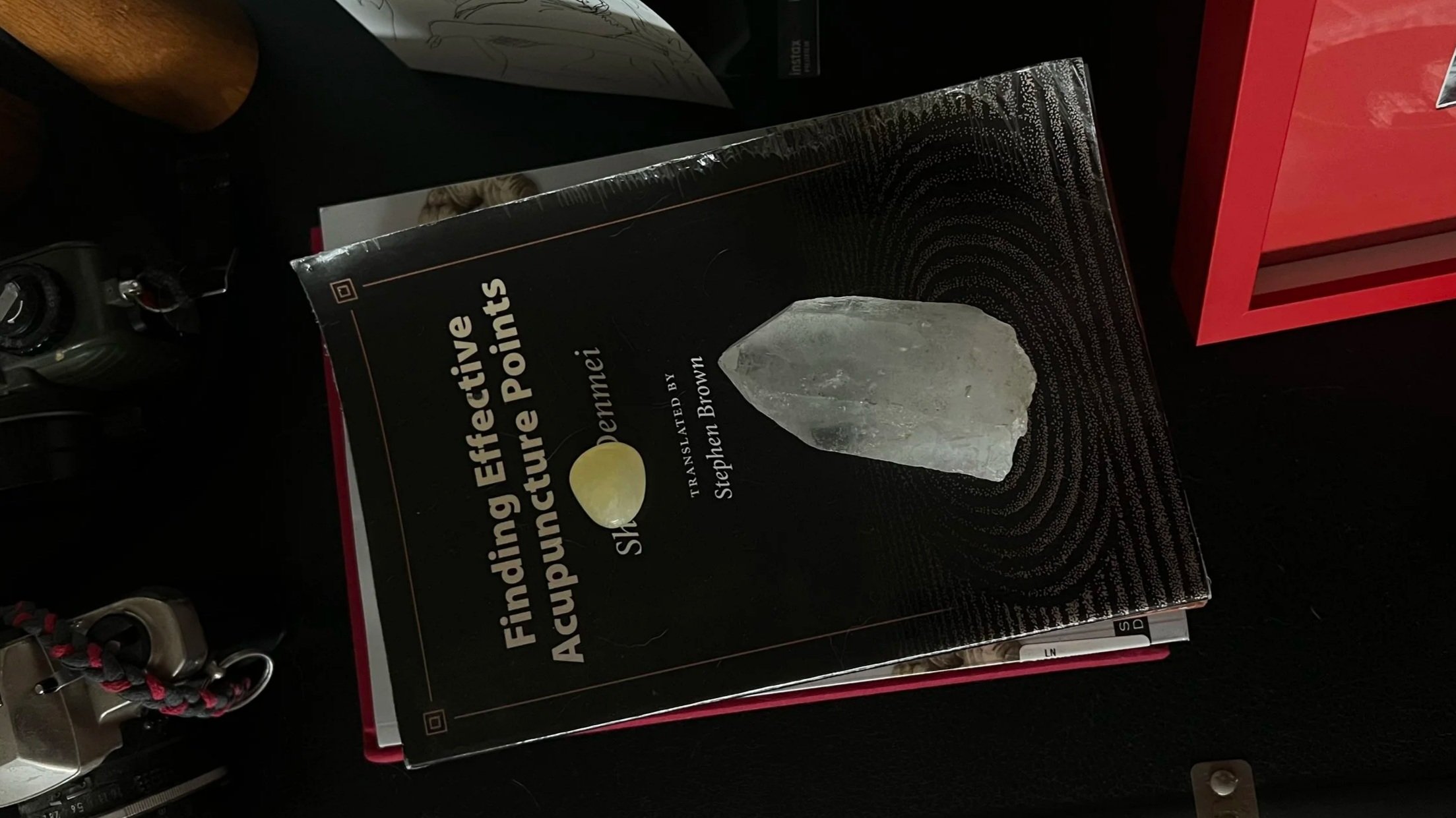 Rein Short L.Ac.'s photo of a book titled 'Finding Effective Acupuncture Points' by Stephen Brown, featuring a clear quartz crystal on the cover. Book explains finding live acupuncture points on each patient for effective treatments.