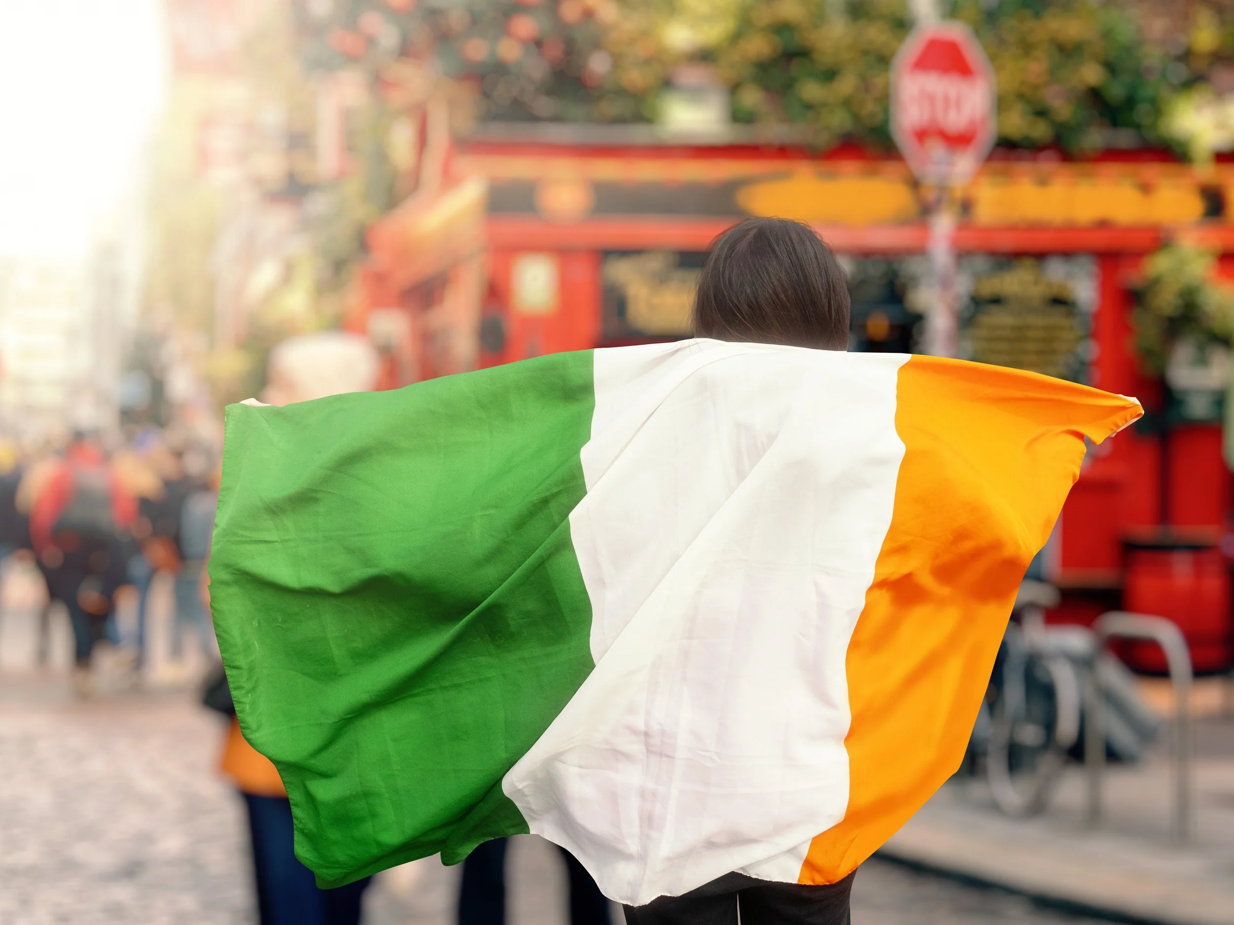 An work experience student on Erasmus internship in Dublin with an Irish flag showing cultural experience in Ireland