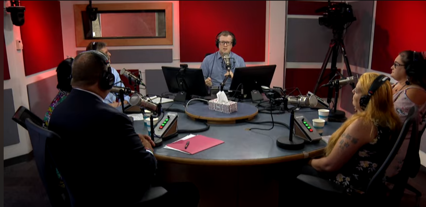 A round-table talk in a radio studio with members of government and women from LLEAG.