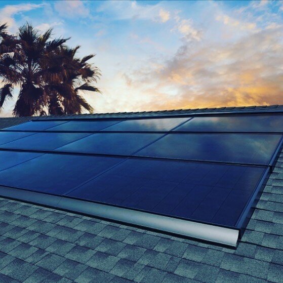 Solaria solar panels on a roof at sunset