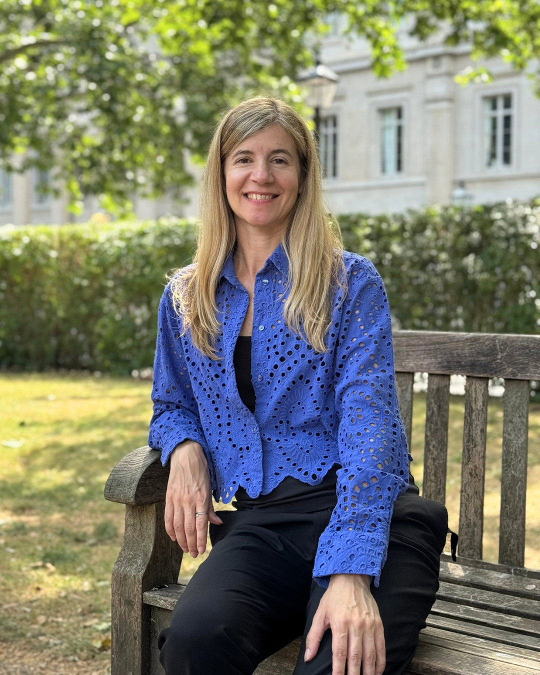 Silvia Martin sat on a bench in London, smiling toward the camera