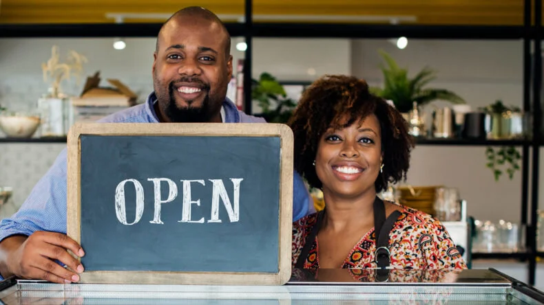bigstock-Cake-cafe-owners-with-open-sig-237514774-e1542241542909-790x444.jpg