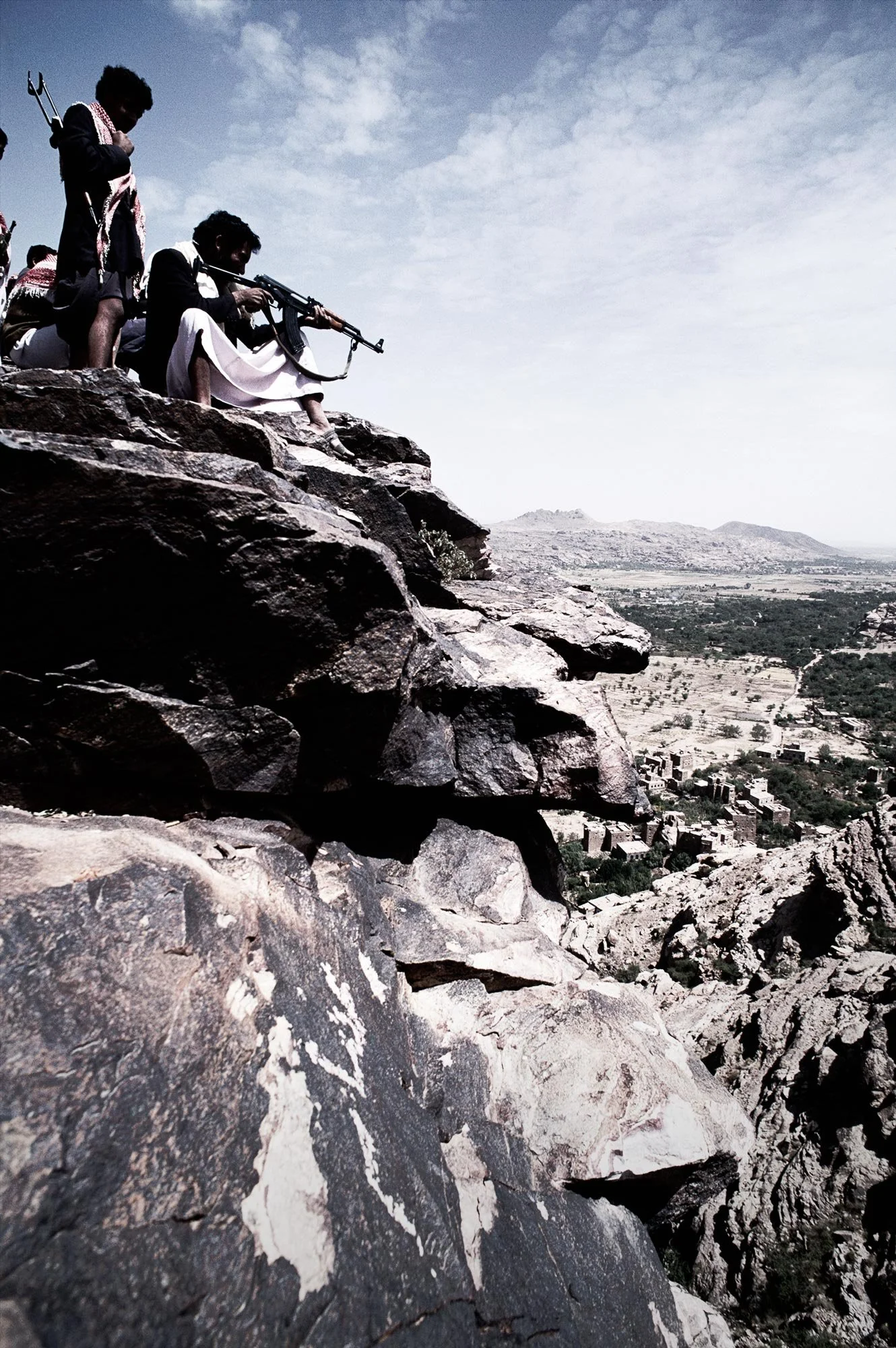 Yemeni Tribesman firing AK47  on the outskirts of Sana'a, Yemen by photographer David.A.Knight © The image was captured while on assignment for Emirates Airllines.