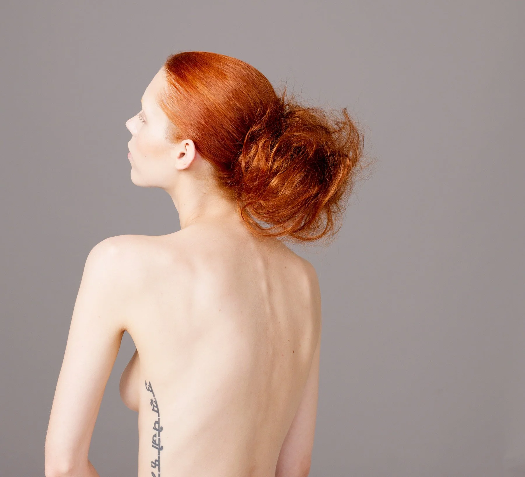 Portrait of  German Fashion model Eilika Meckbach with tatoo and flaming red hair by Sydney photographer David.A.Knight ©