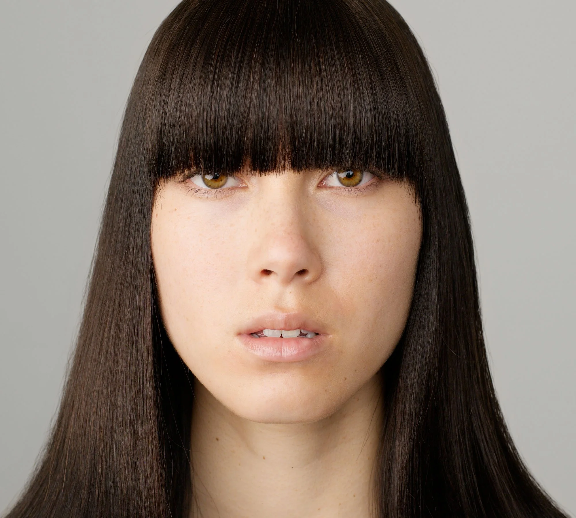 Studio portrait of Lauren with eyes open and straight fringe from the series 'Curiosity' by photographer David.A.Knight ©