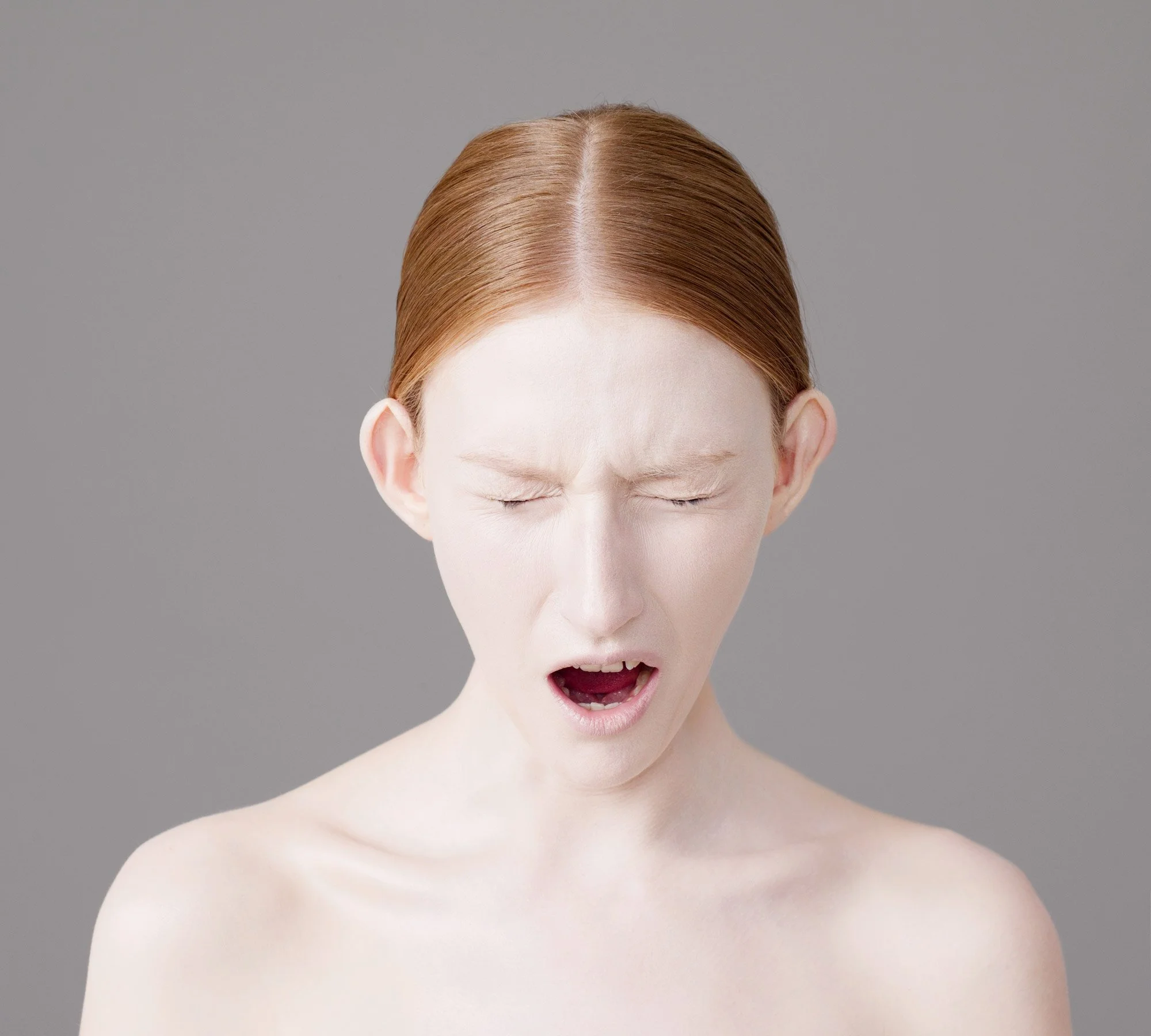 Studio portrait of Lauren screaming with eyes closed shut from the series 'Curiosity' by photographer David.A.Knight ©